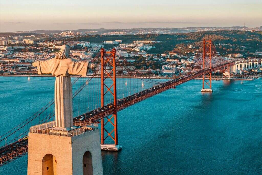 En vy över den vackra, röda hängbron "Ponte 25 de Abril" i Lissabon, Portugal.